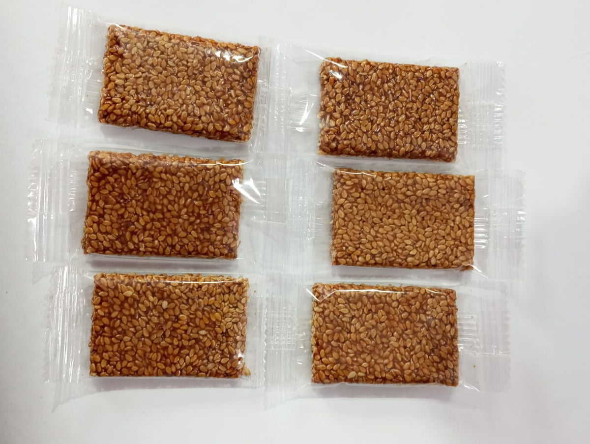 Harishi sesame chikki (til chikki) bars made with roasted sesame and jaggery for healthy snacking and well-packed to maintain freshness.