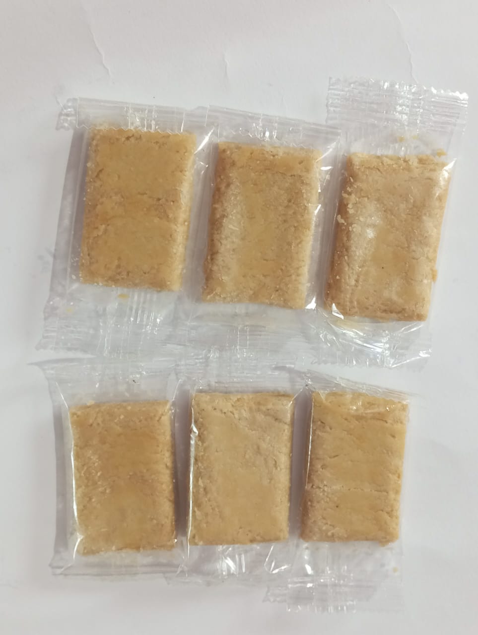 Close-up of handcrafted peanut butter chikki showing crunchy peanut texture with goodness of butter and peanut.